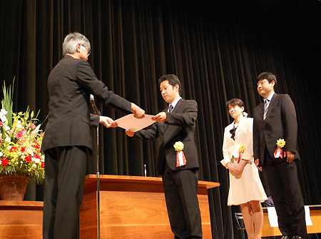 本保長官(左)から表彰を受ける米沢市立北部小学校の教諭ら